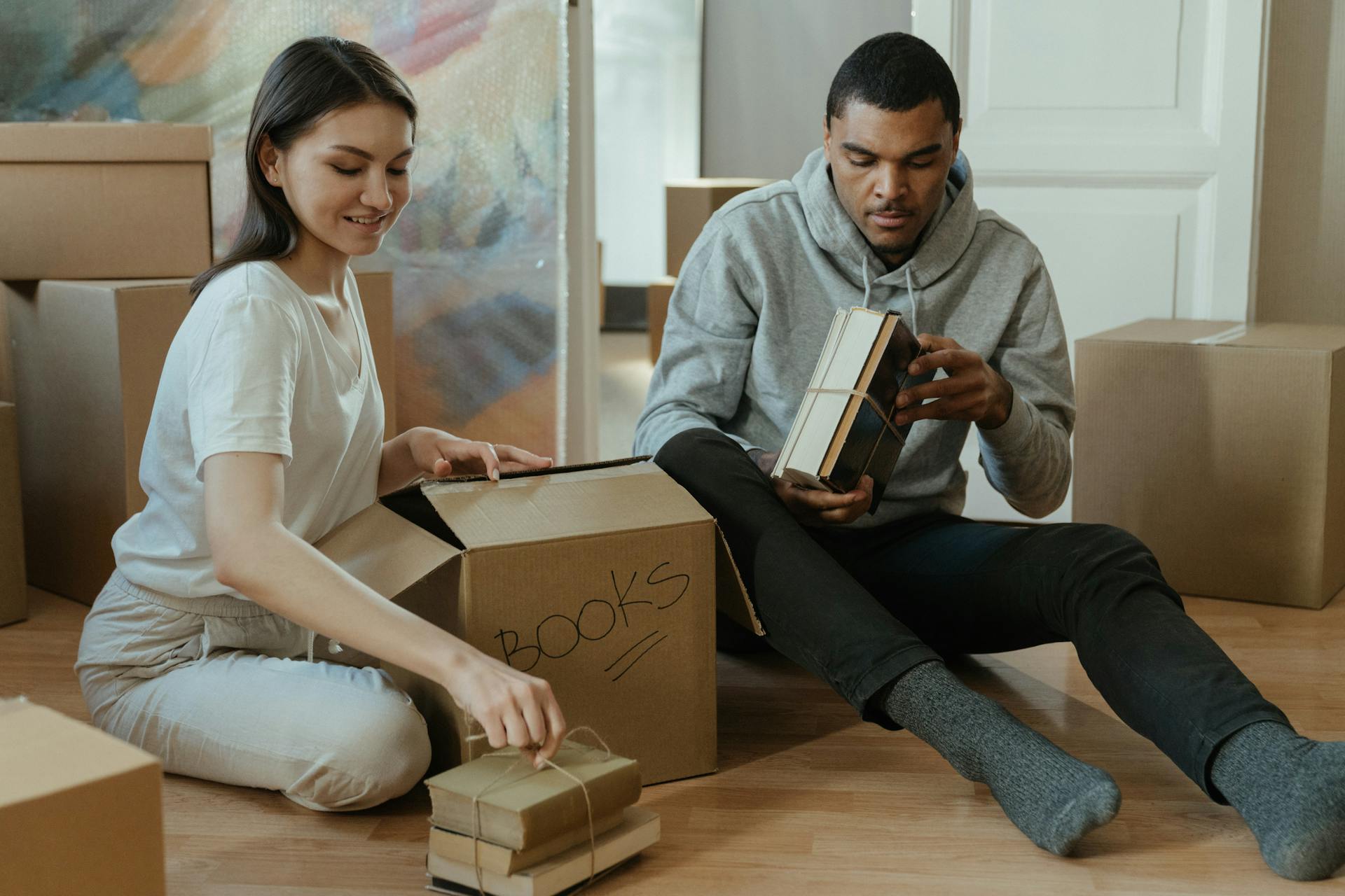 Man in White Button Up Shirt Holding Brown Box