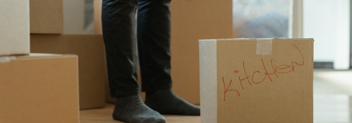 Moving boxes stacked by a person's feet