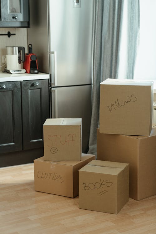 Free Brown Cardboard Boxes on White Wooden Cabinet Stock Photo