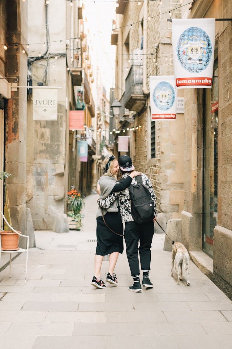 Back View Of A Couple Walking With A Dog