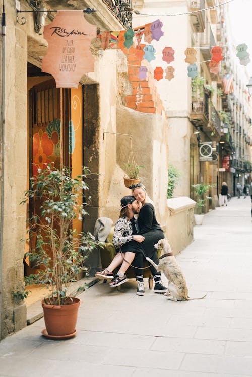 A Romantic Couple Cuddling while Sitting on a Chair