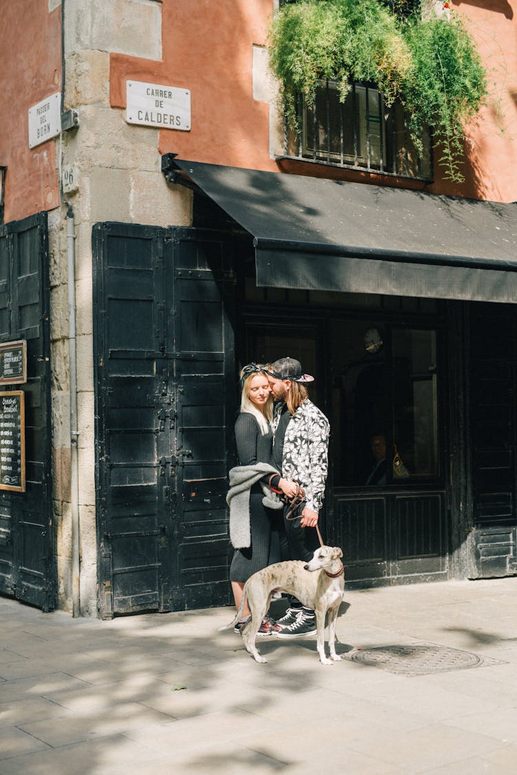 A Romantic Couple With A Dog On The Street