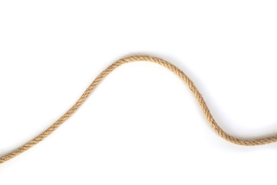 A twisted rope elegantly curves across a clean white background.