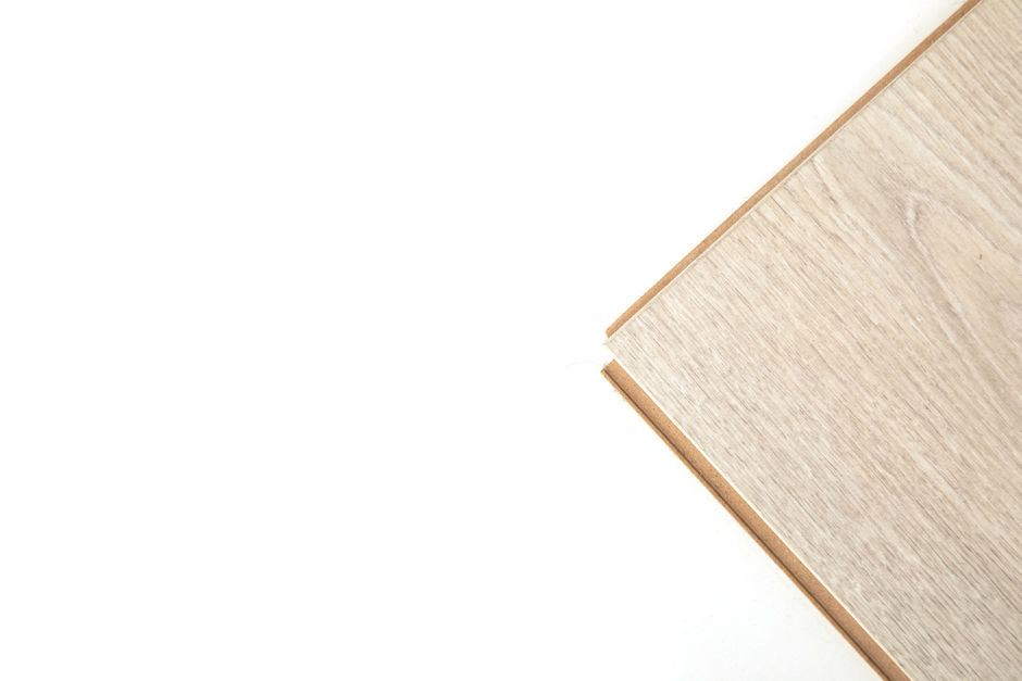 Close-up of a light wooden plank against a white background with copy space.