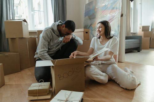 Man in Gray Sweater Sitting Beside Woman in Gray Sweater