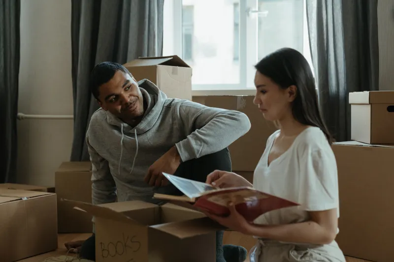 Couple unpacking moving boxes in a new home