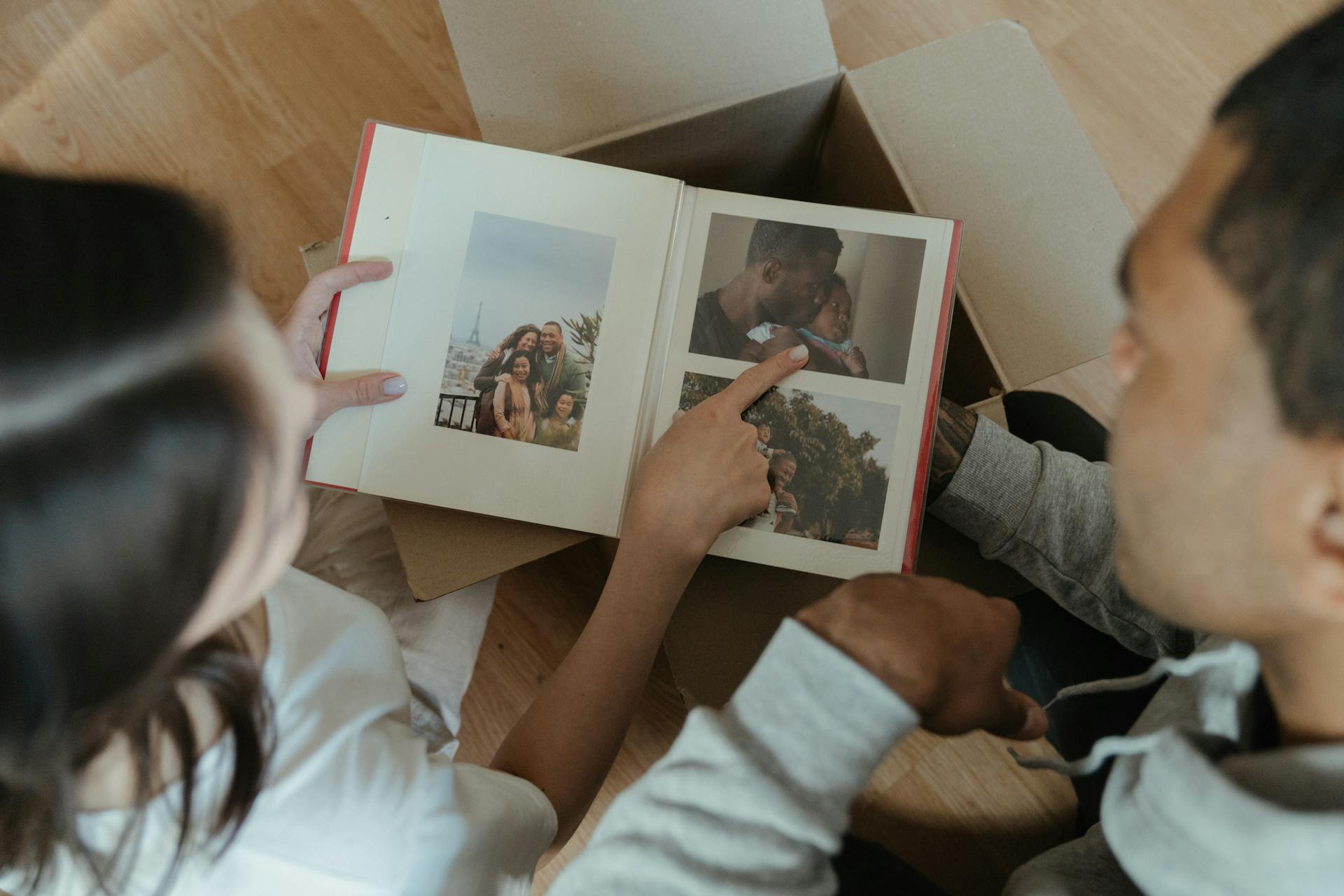 Person Holding 2 Photos of 2 Women