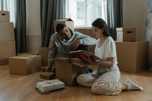 Man and Woman Sitting on Brown Wooden Table