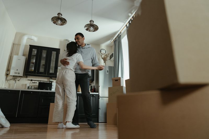 Happy couple settling into a Philadelphia home with moving boxes