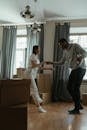 Man in White Dress Shirt and Black Pants Standing Beside Woman in White Long Sleeve Shirt