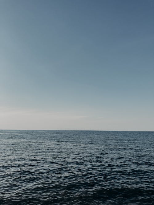 Picturesque seascape of blue rippling surface of endless sea under bright clear sky