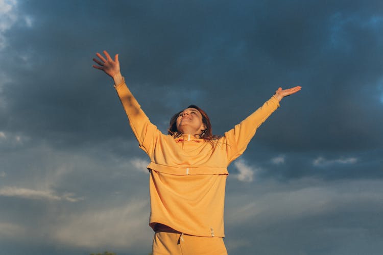 Excited Woman Against Overcast Sky