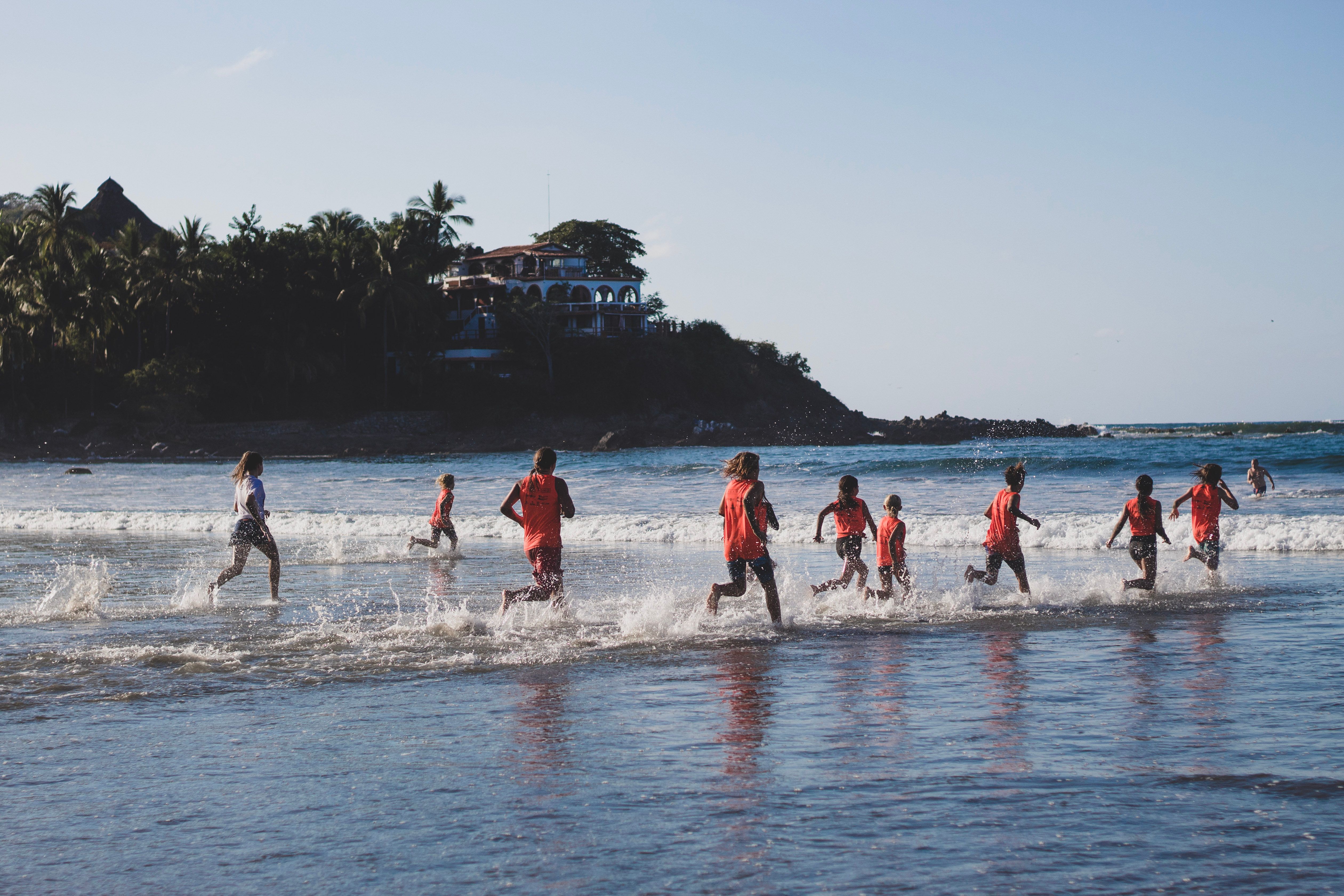 People running on seashore during training · Free Stock Photo