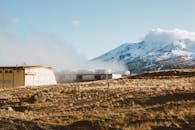 Snowy mountain covered with clouds and flat plain