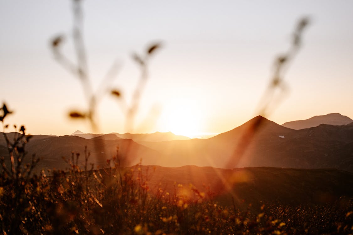 Amazing sunset over hills and rural meadow