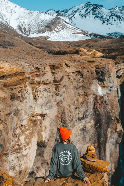 A Person Sitting on the Edge of the Cliff