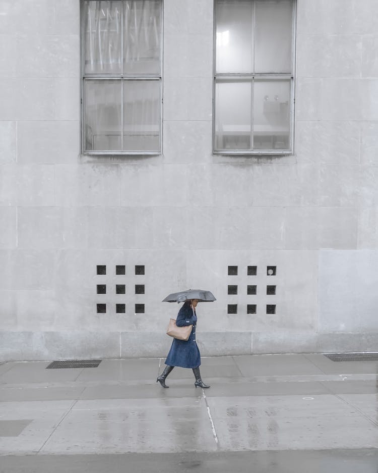 Unrecognizable Woman Walking Under Rain