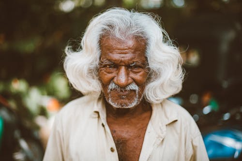 Optimist elderly ethnic man on urban street