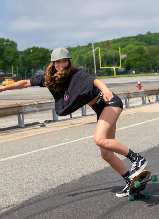 Premium Photo  Adult woman enjoy skating on longboard on empty city street  happy cheerful woman holding skateboard