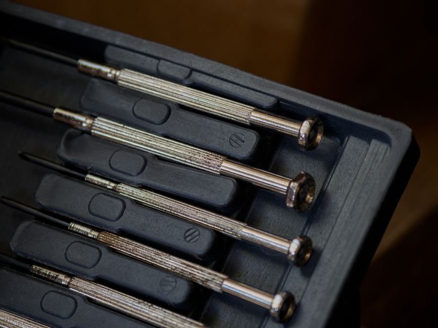 Precision screwdriver set and tweezers on a magnetic mat - snes oled display install Precision screwdriver set and tweezers on a magnetic mat - snes oled display install