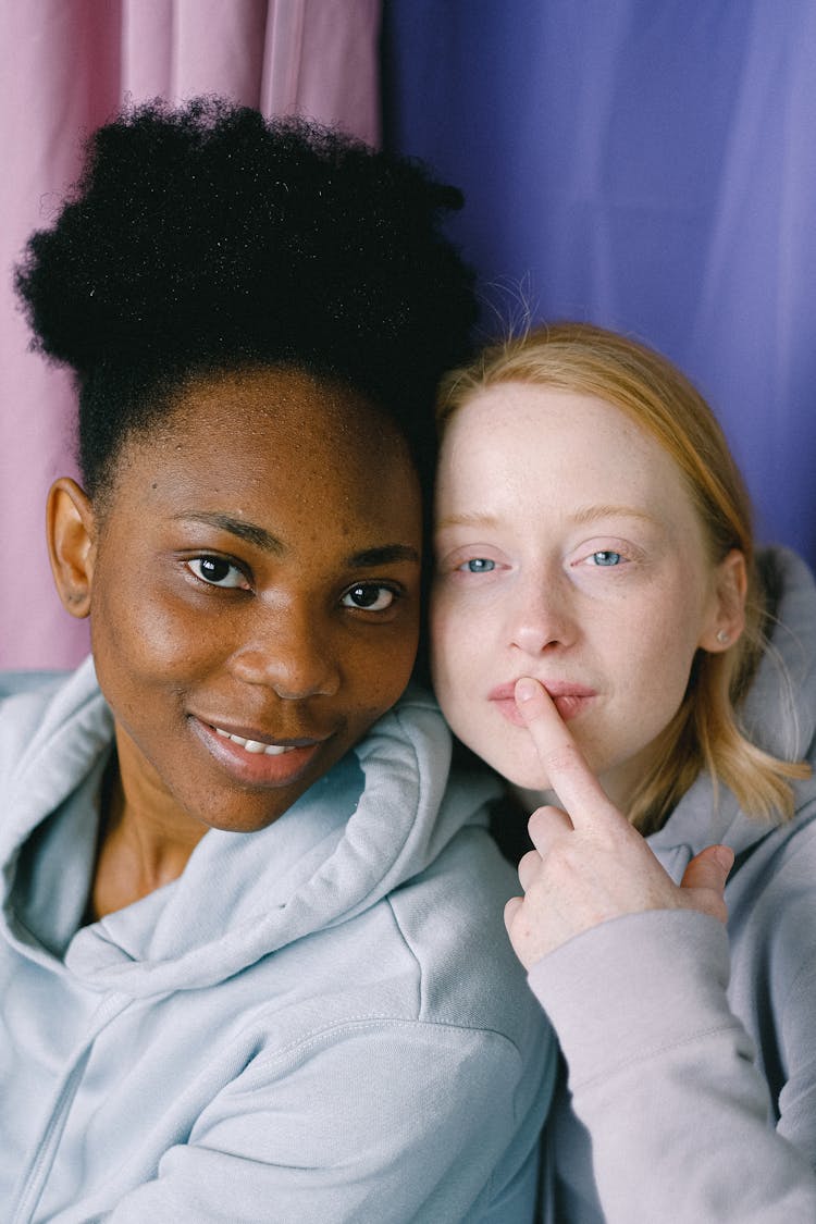 Women Wearing Hoodies Looking At Camera