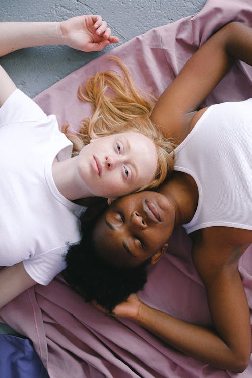 Free Two Women Lying Together on the Floor Stock Photo