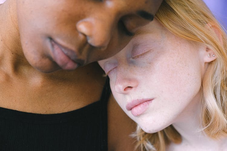 Heads Of Interracial Women Leaning On Each Other