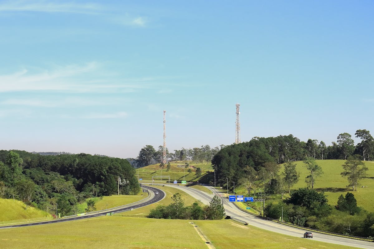 Person reading a newspaper while holding a coffee cup