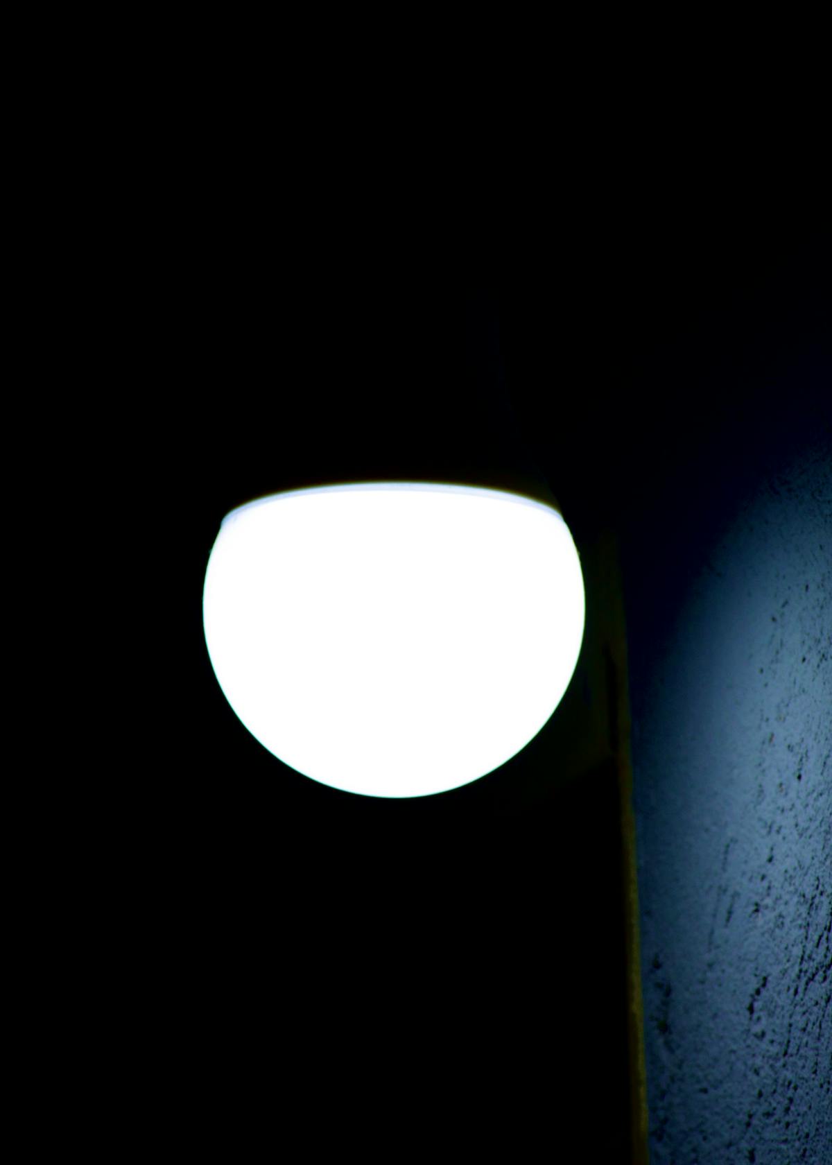 Person sitting by a window, silhouetted, suggesting reflection and emotional weight