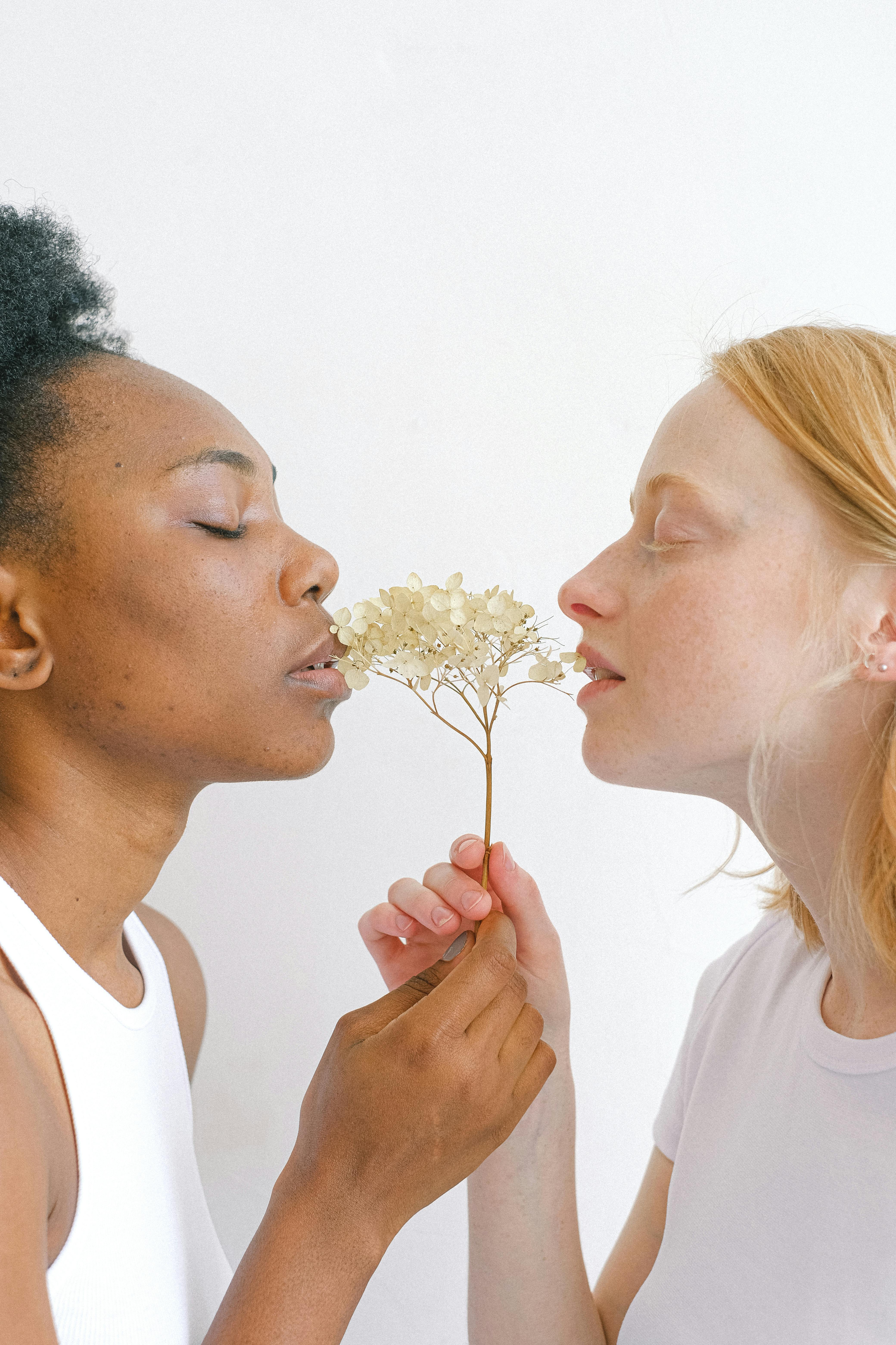 women holding white flowers