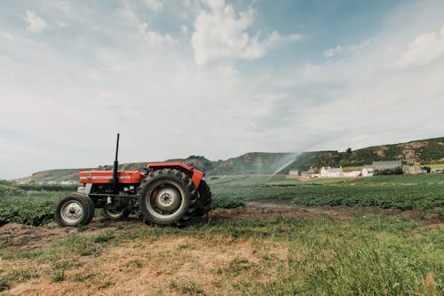 Tractor plowing soil in countryside in daytime