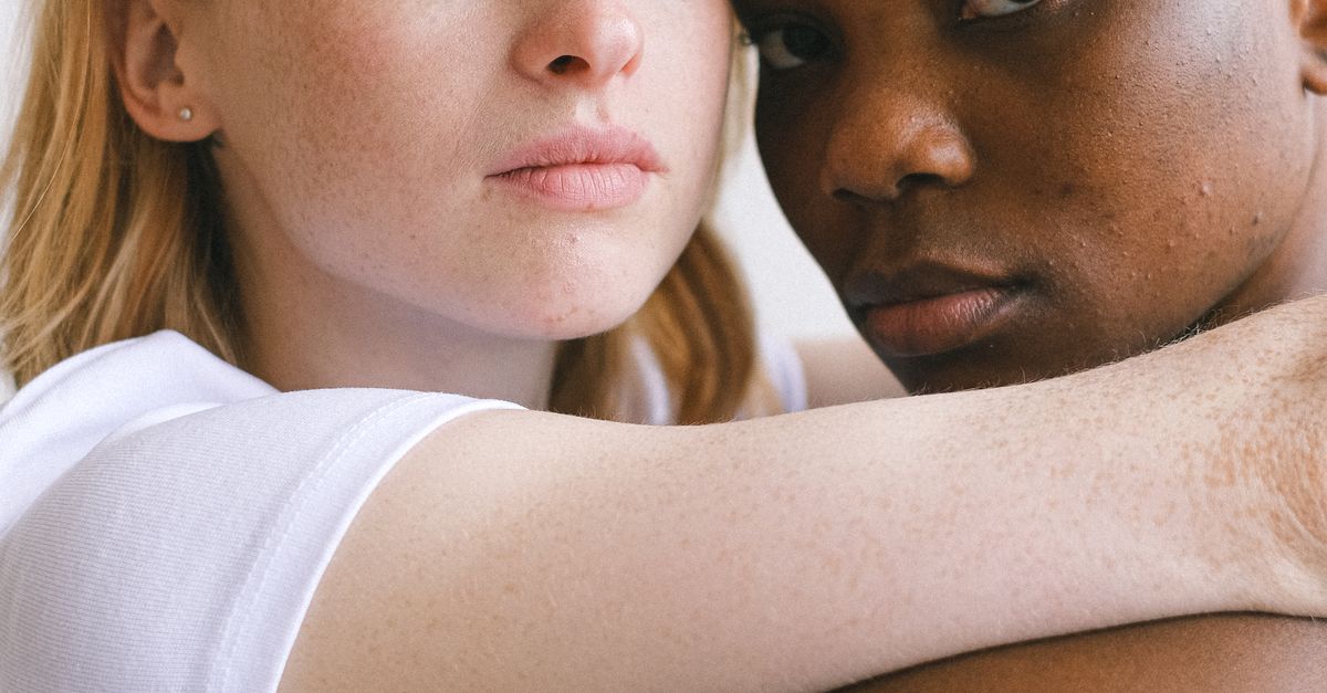 Hugging The Camera Women Hugging and Looking at the Camera · Free Stock Photo