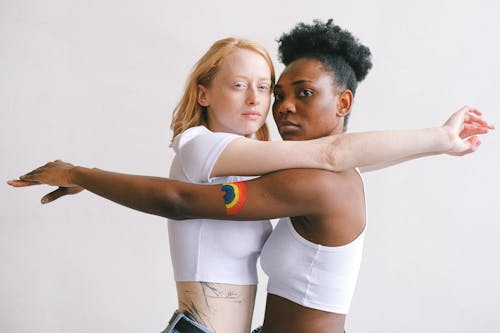 A tender embrace between an interracial lesbian couple expressing love and pride.