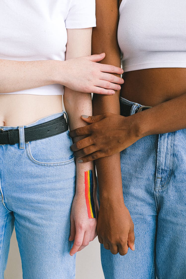 Close Up Of Women Touching Arms