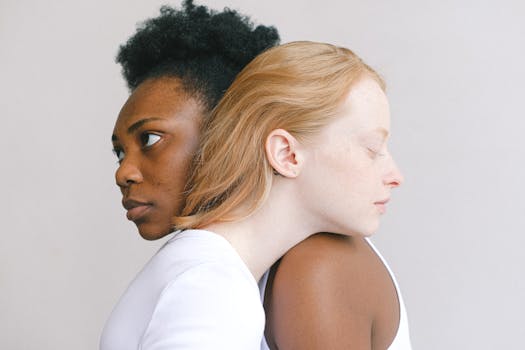 A tender embrace between two women highlighting love and diversity in a studio environment.