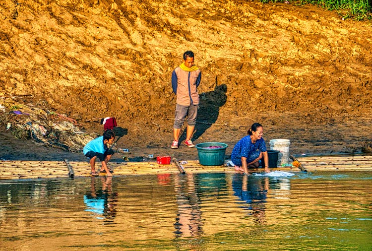 Woman Washing Clothes In The River