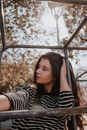 Young Girl in Black and White Striped Near Metal Jungle Gym