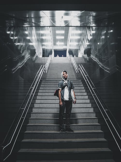 Man Standing on Concrete Stairs in the Building