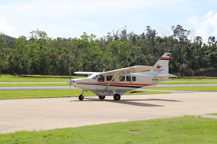 Modern Utility Aircraft Preparing For Flight In Field