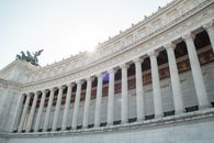 From below of majestic columns of Altare della Patria in Rome on sunny day