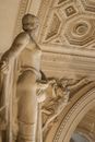 From below of graceful statue in wonderful interior with ornate walls and lavish stucco molding on ceiling