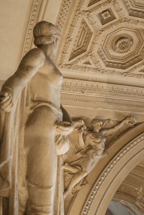 Free From below of graceful statue in wonderful interior with ornate walls and lavish stucco molding on ceiling Stock Photo