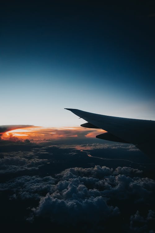 Aircraft wing and clouds at dawn