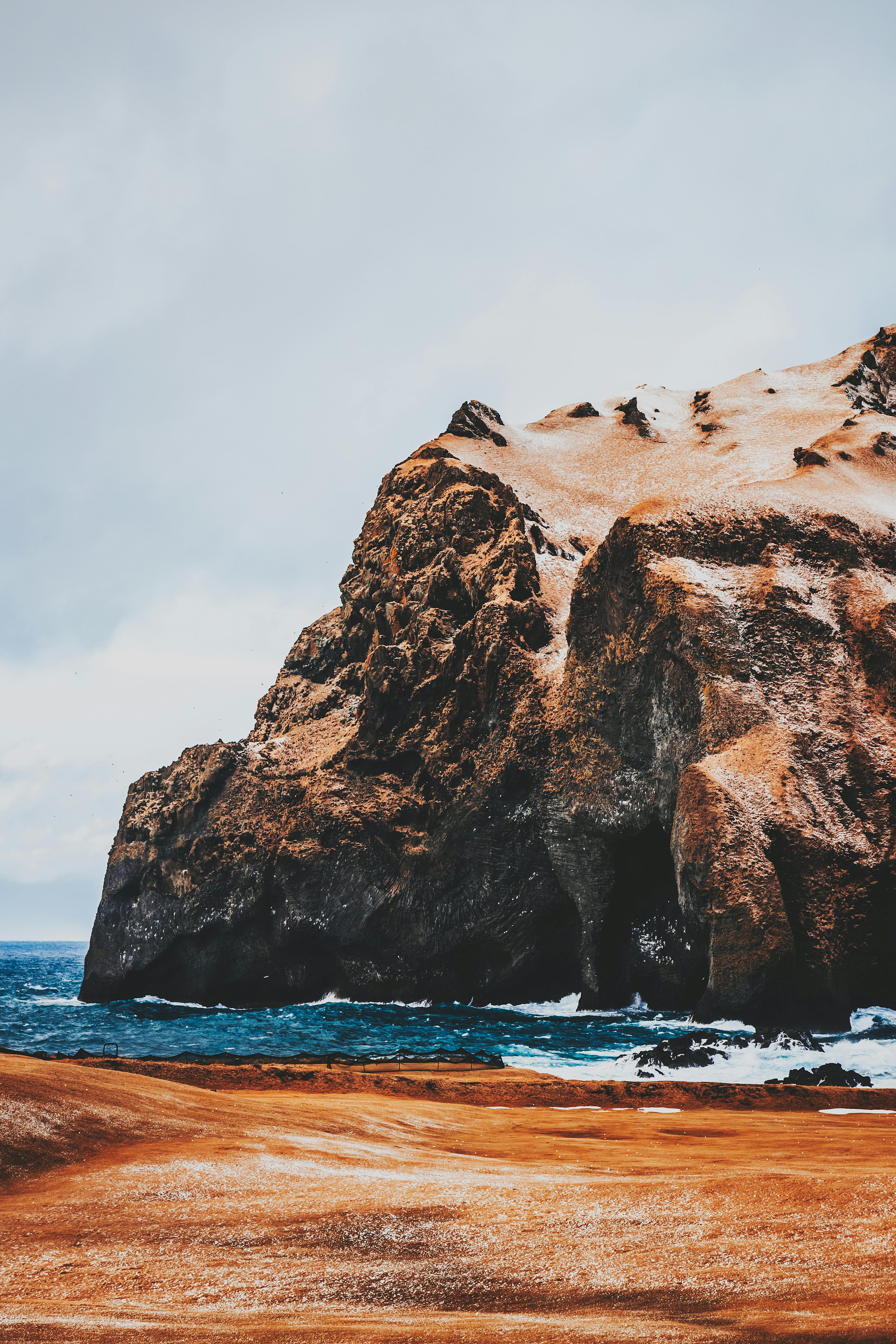 grey sky over steep rock