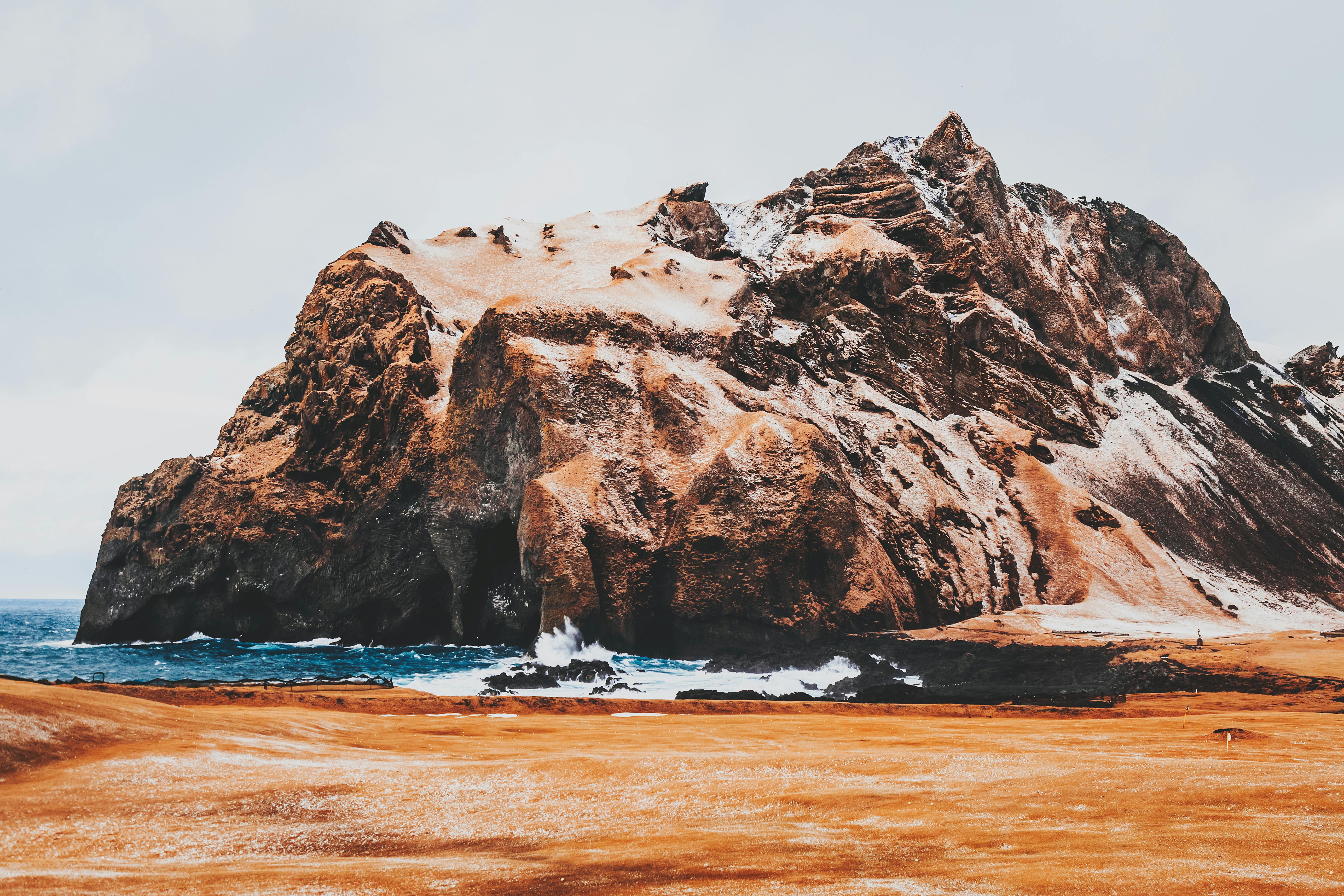 steep mountain on coast of ocean