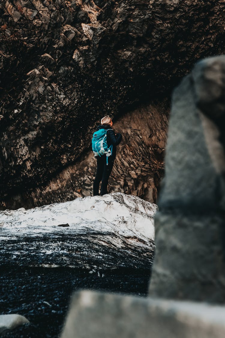 Unrecognizable Hiker On Big Rock Ledge