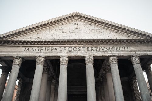 Free From below of large granite Corinthian columns and stone facade with Latin inscription of spectacular antique Pantheon in Rome Stock Photo