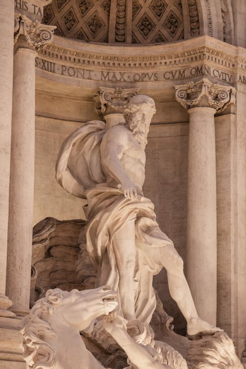 Free Stone sculpture depicting Oceanus at majestic Baroque Trevi Fountain made of travertine stone in Rome Stock Photo