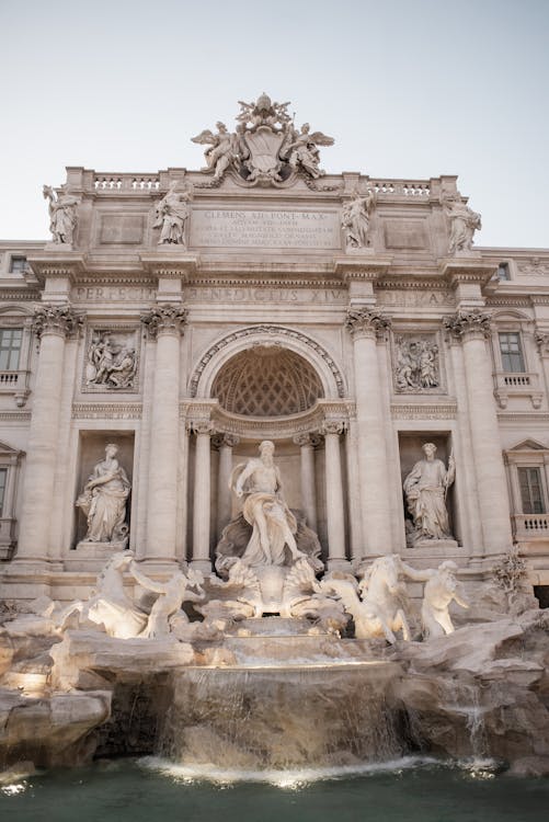 Free Wonderful Trevi Fountain with graceful statues in front of Palazzo Poli in Rome Stock Photo