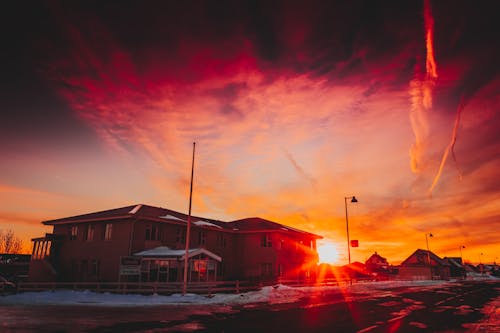 Sun setting over village in winter